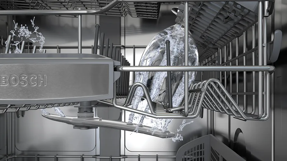 Bosch dishwasher interior with water spraying onto dishes from a rotating arm.