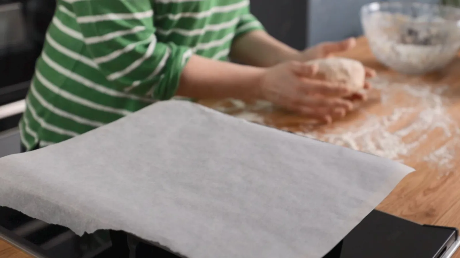 Person mixing ingredients to form dough