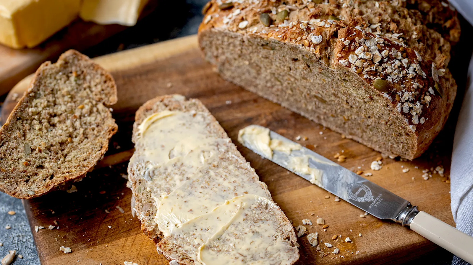 Wholewheat Seeded Soda Bread that has been buttered with butter knife on top