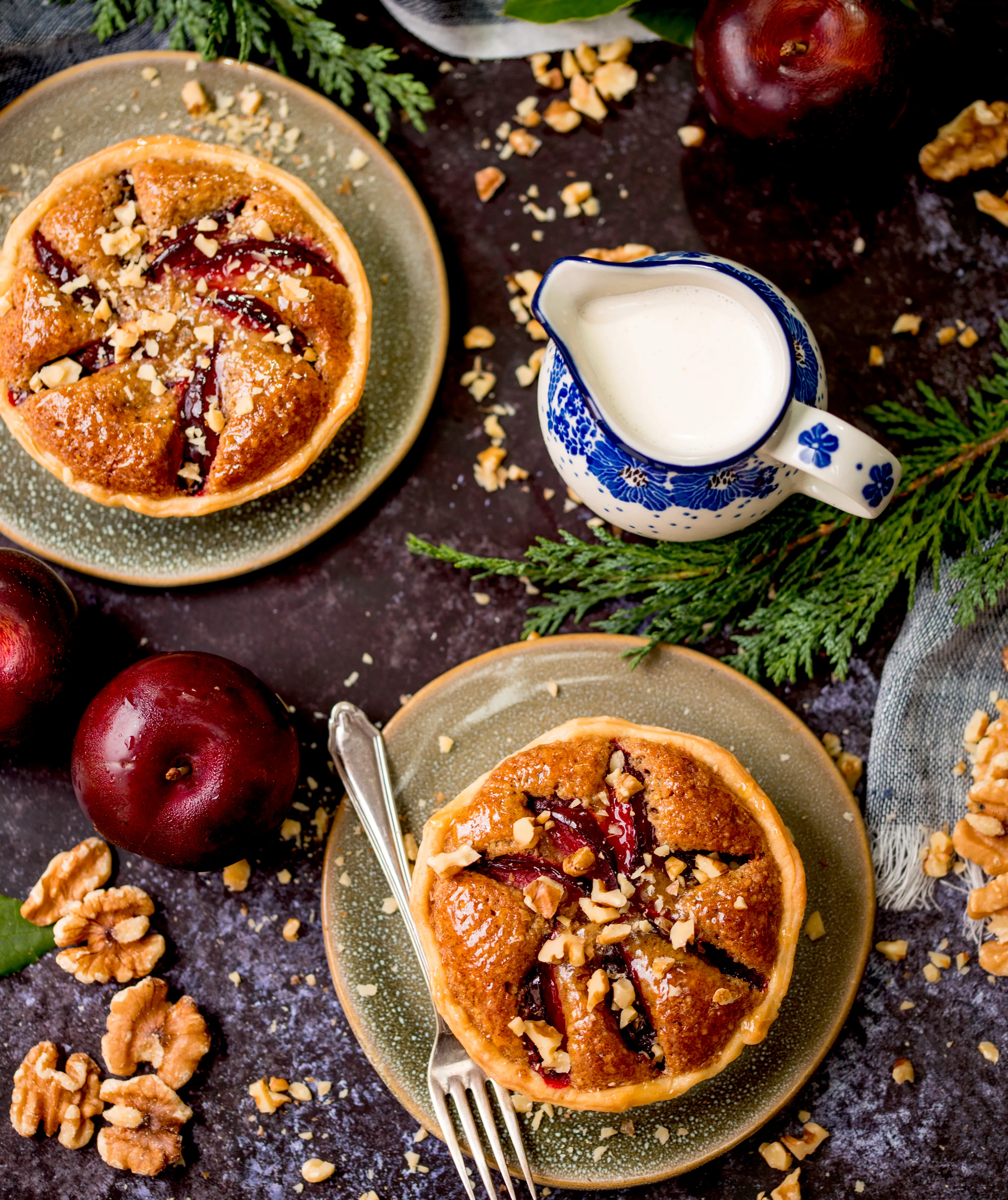 Plum and ginger tart with walnut on festive background