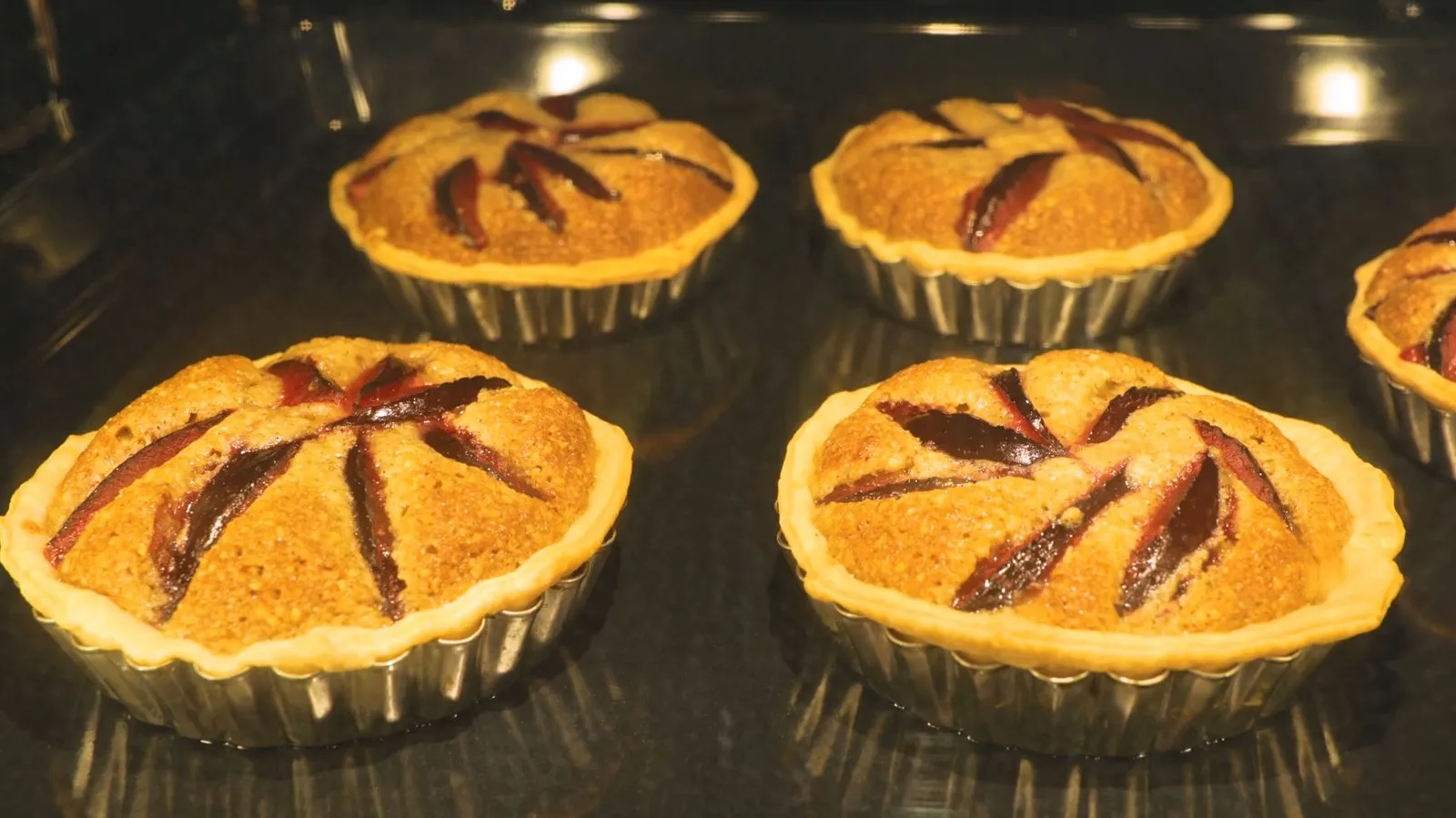 Close up of tarts cooking in oven