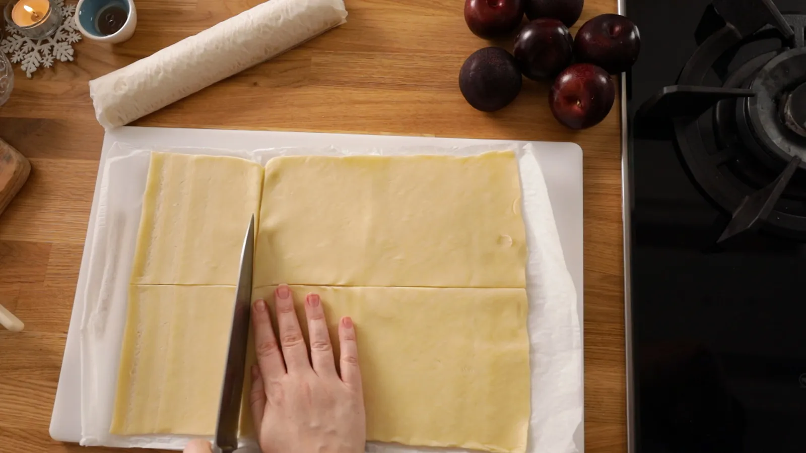Person cutting pastry sheet into squares