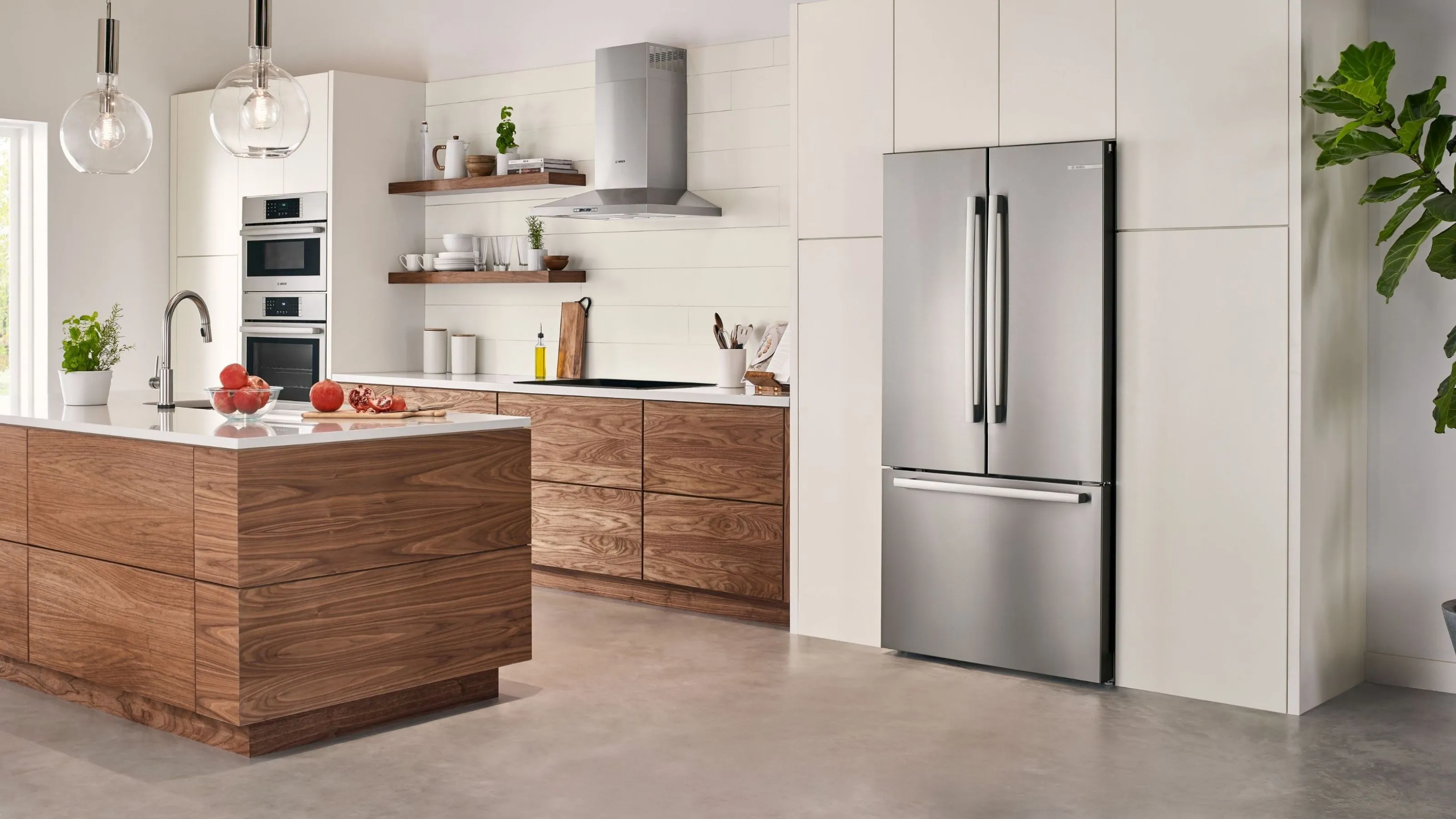 Modern kitchen with Bosch 36 inch stainless steel refrigerator, other Bosch appliances and wooden cabinets