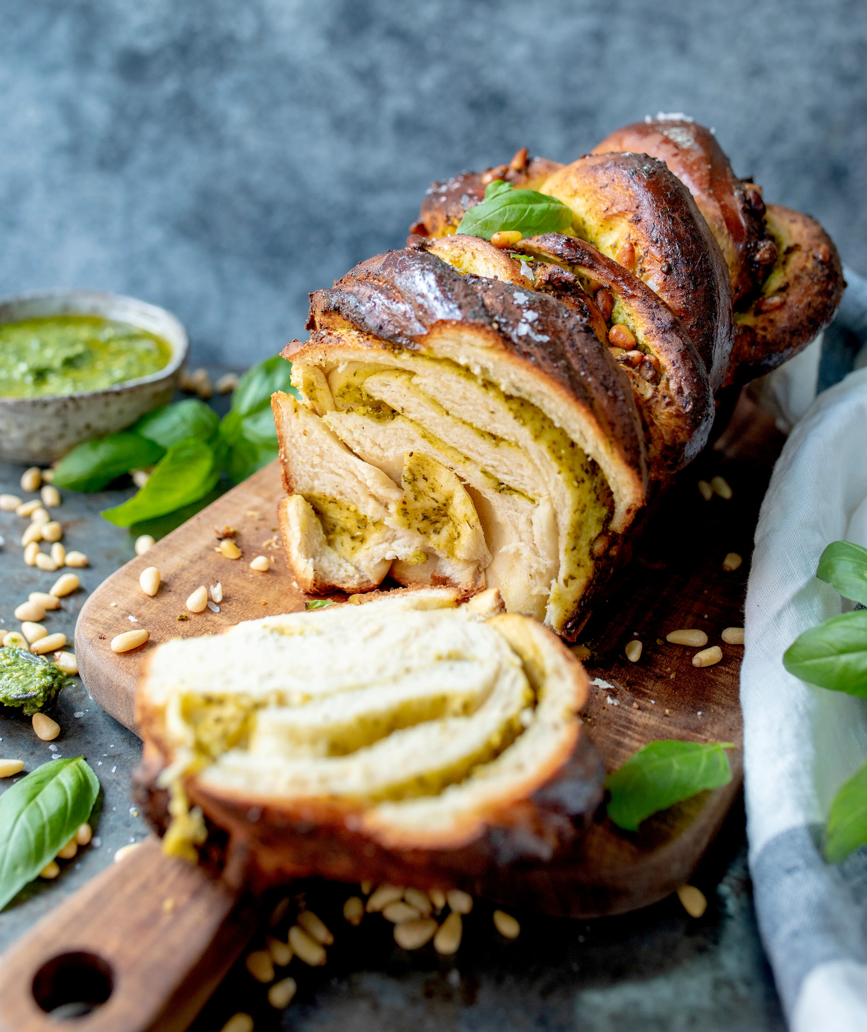 Swirled pesto babka on a wooden board