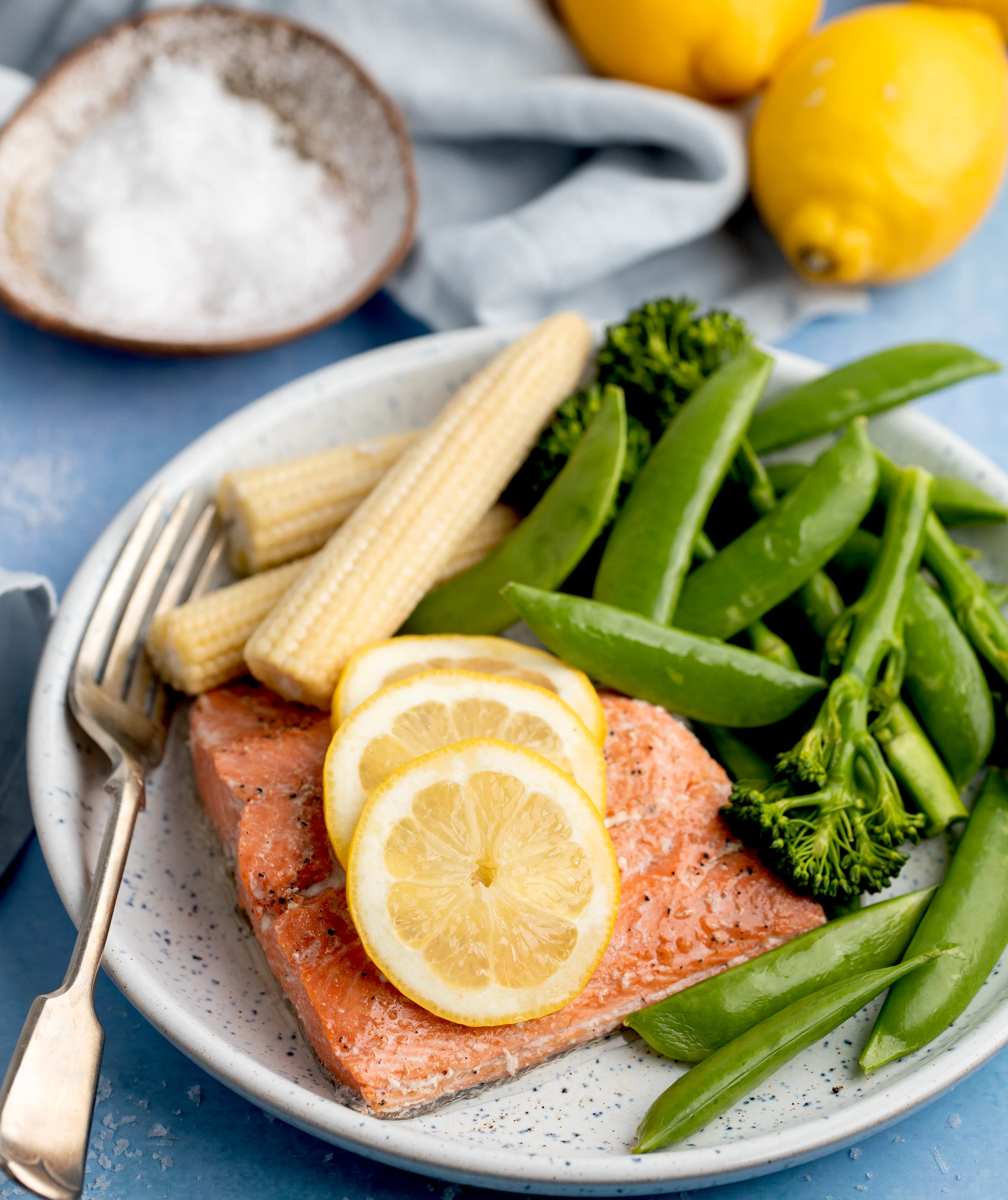 Salmon on plate with lemon and veg