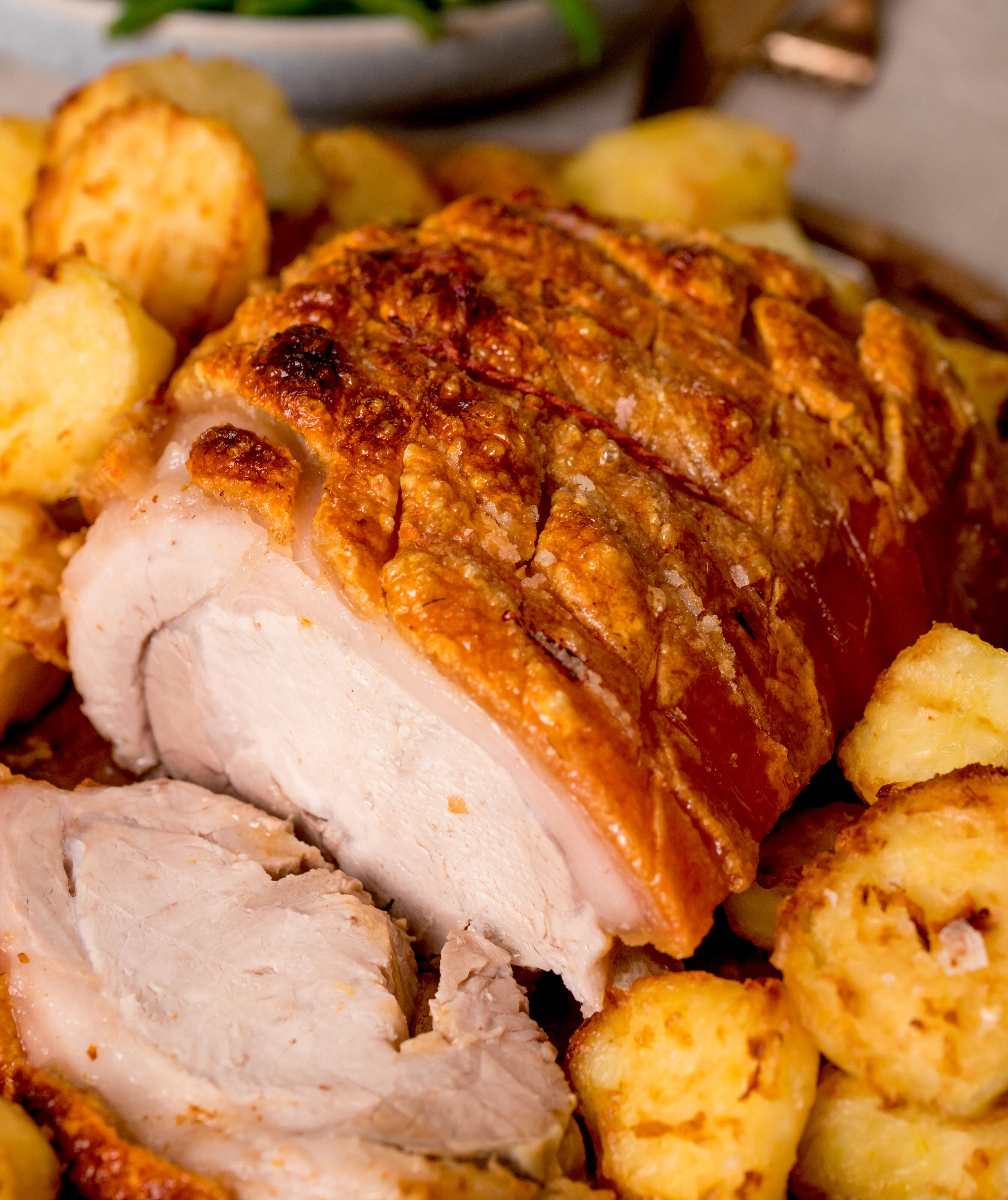 Roast pork on a bed of roast potatoes