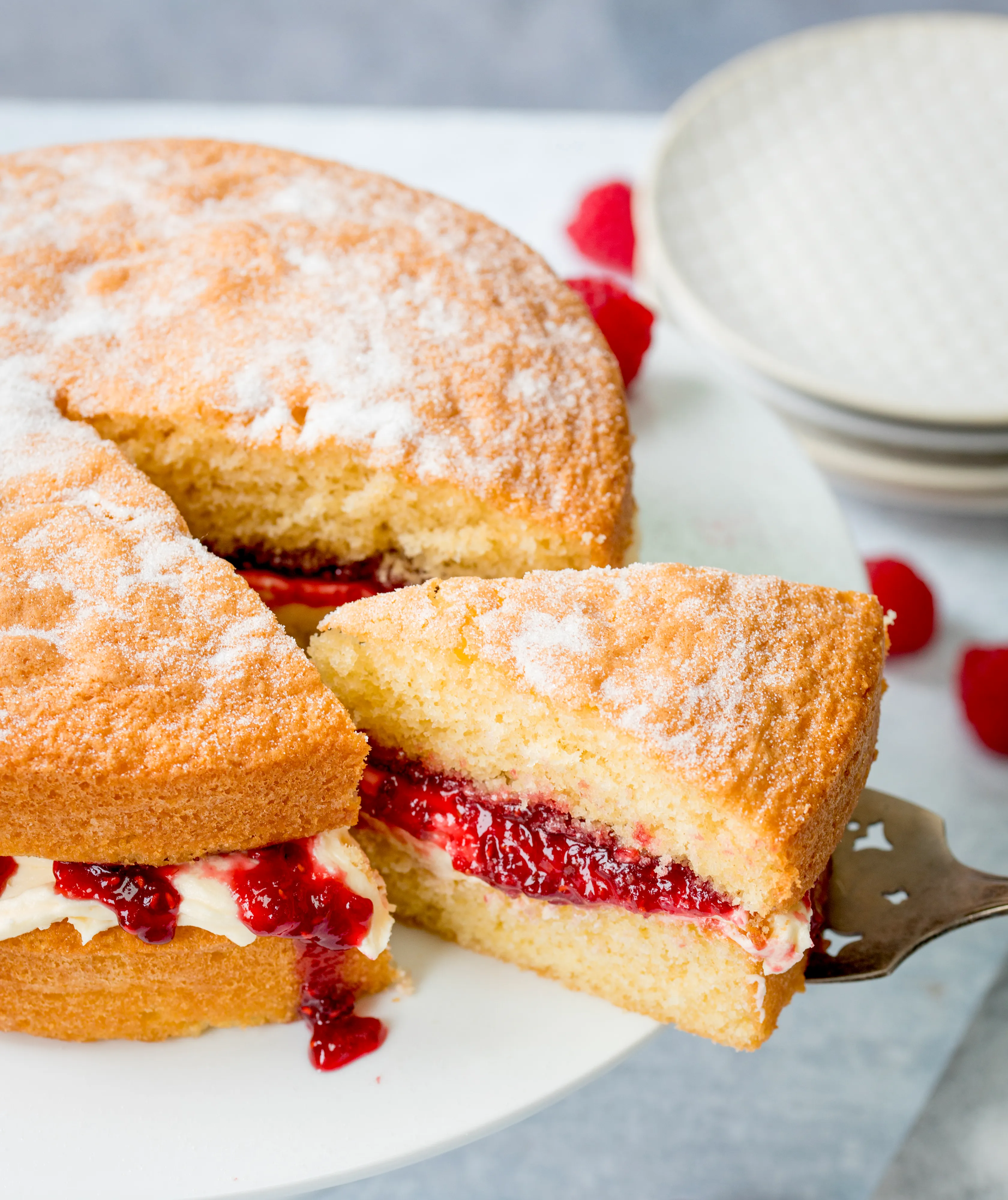Classic Victoria sponge cake slice on cake stand