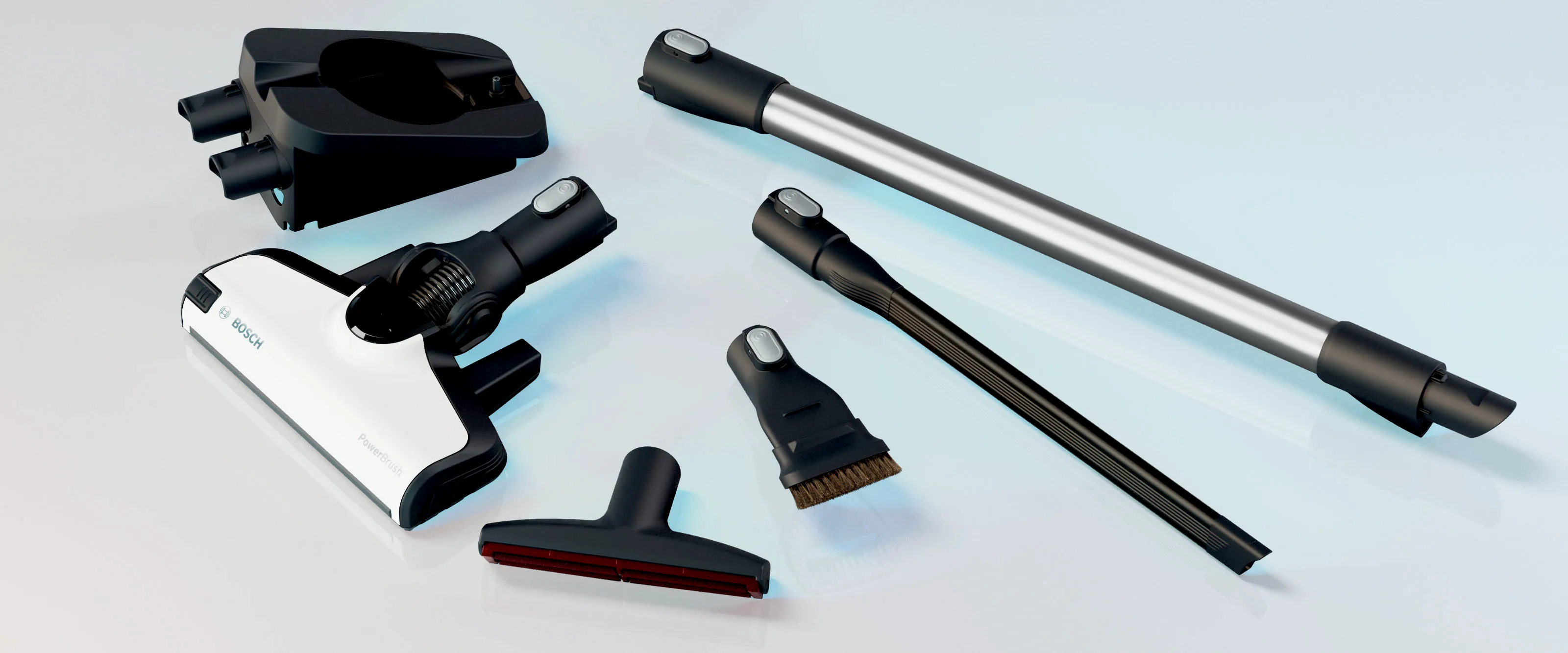 Accesorii de aspirator: furtun, perie, instrument de crevasare, și alte accesorii pe un fundal ușor.