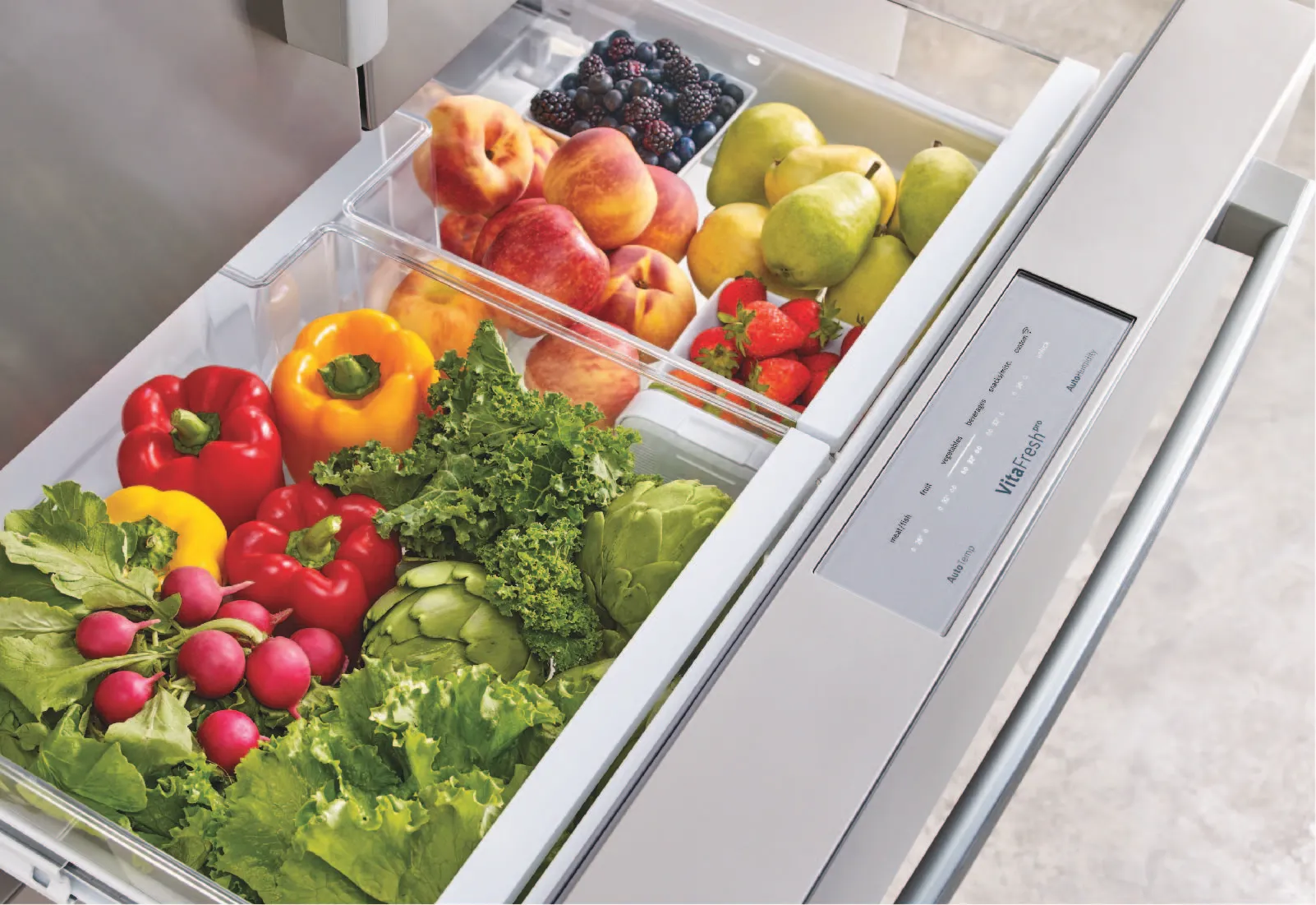 Bosch Refrigerator drawer filled with various vegetables and fruits like peppers, lettuce, and berries.