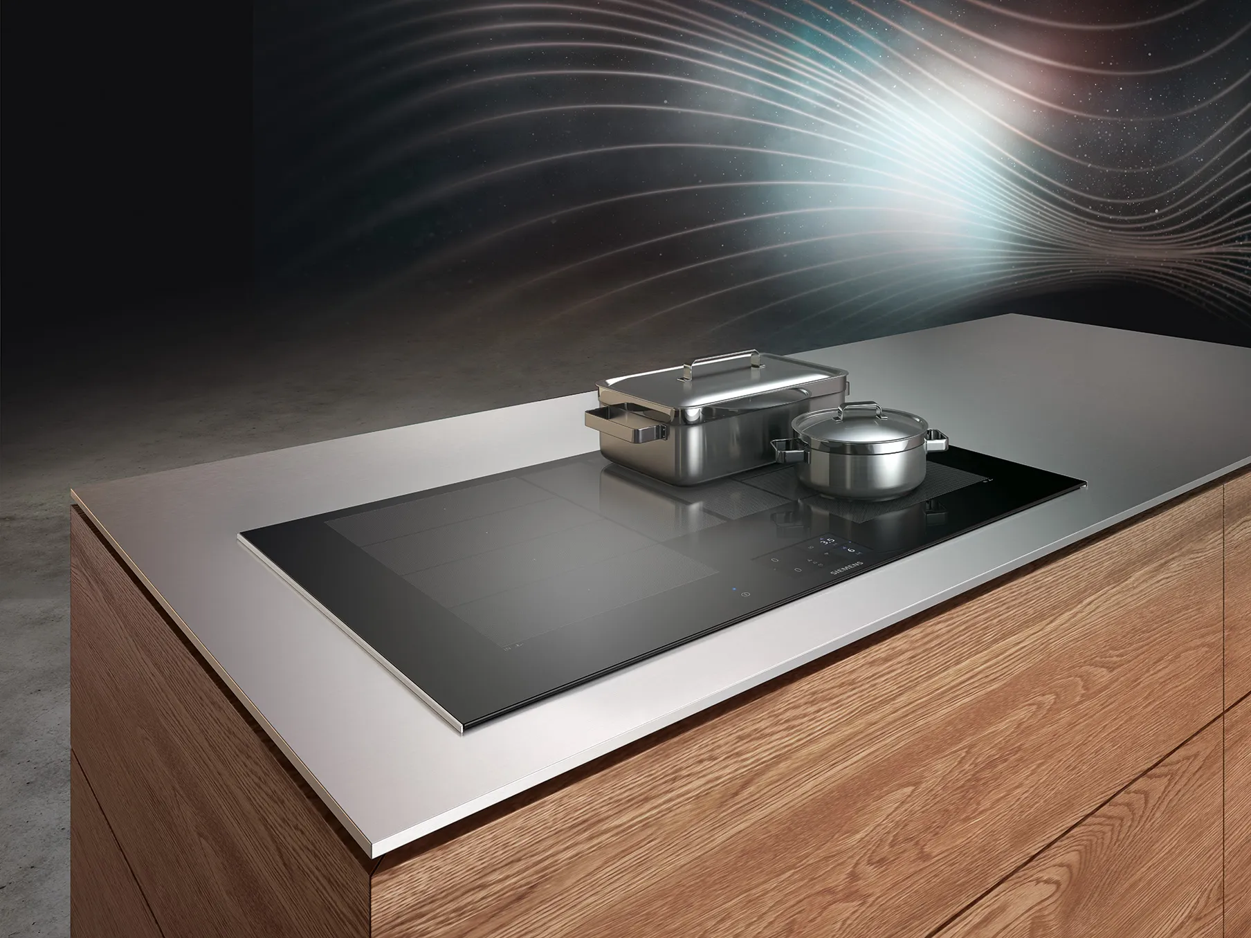Modern kitchen countertop with induction cooktop, stainless steel cookware, and abstract lighting effect.