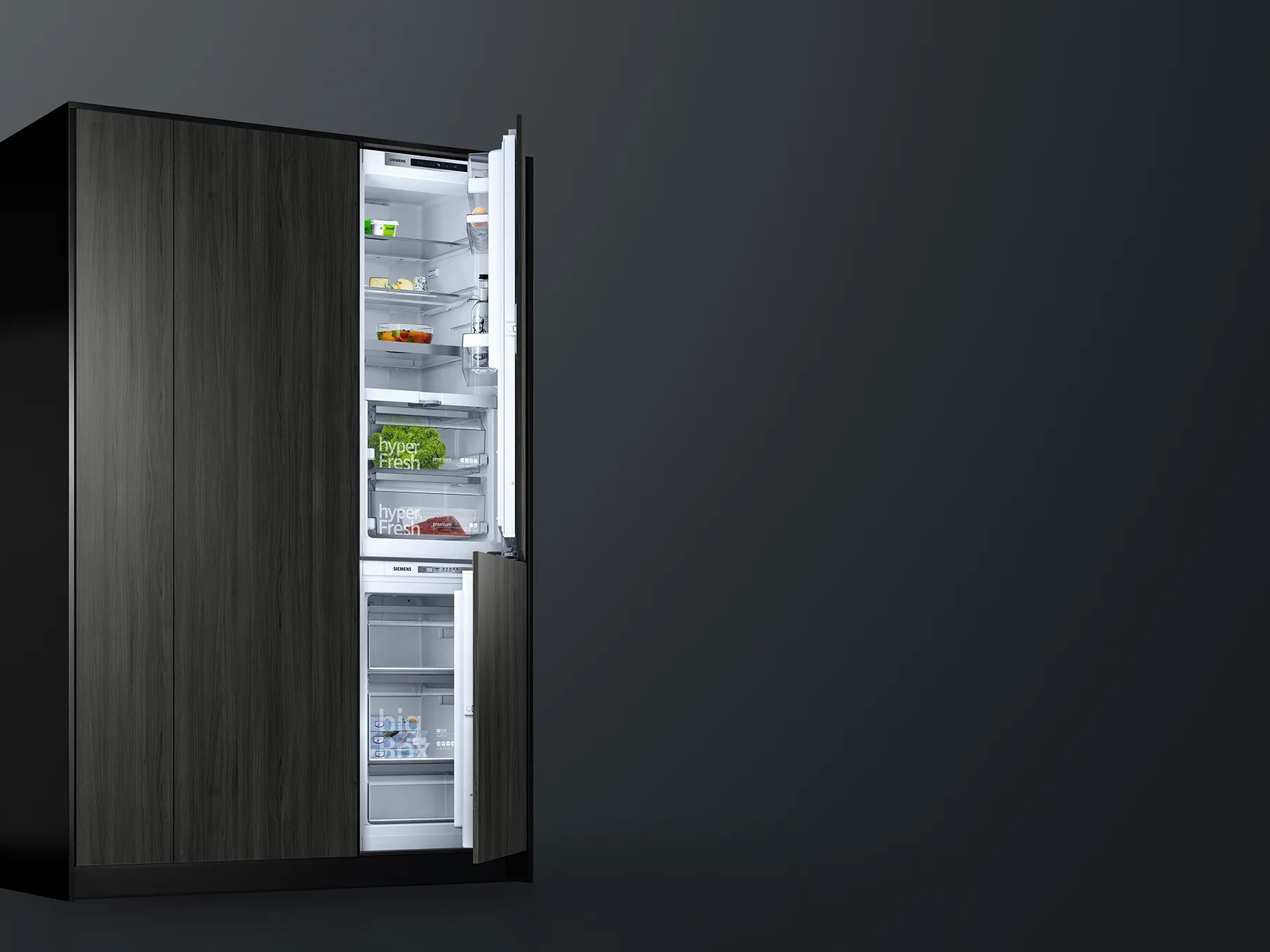 Built-in upright freezer with the door open, revealing seven clear pull-out drawers containing assorted frozen items.
