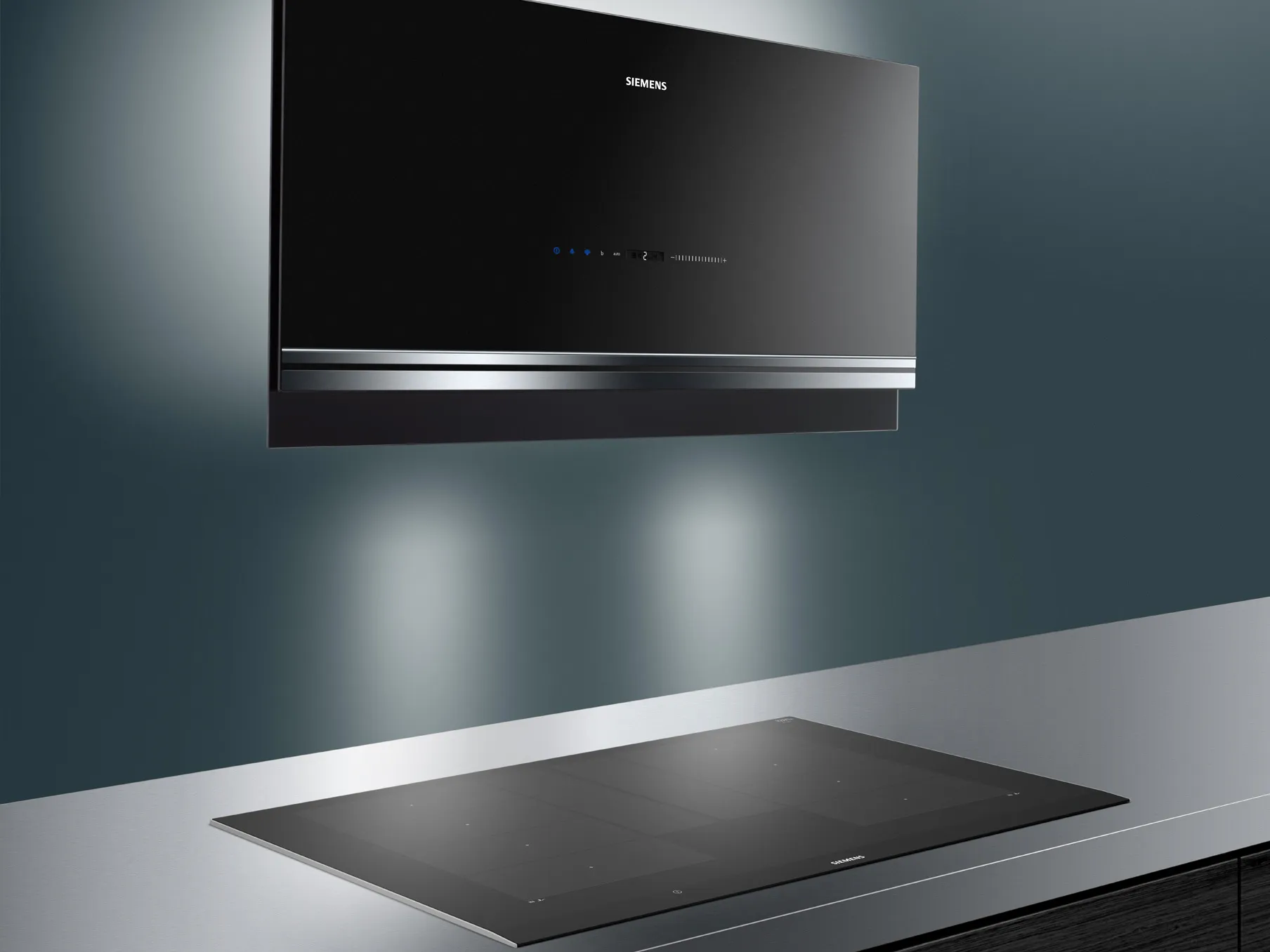 Black built-in oven and induction cooktop on modern kitchen counter.