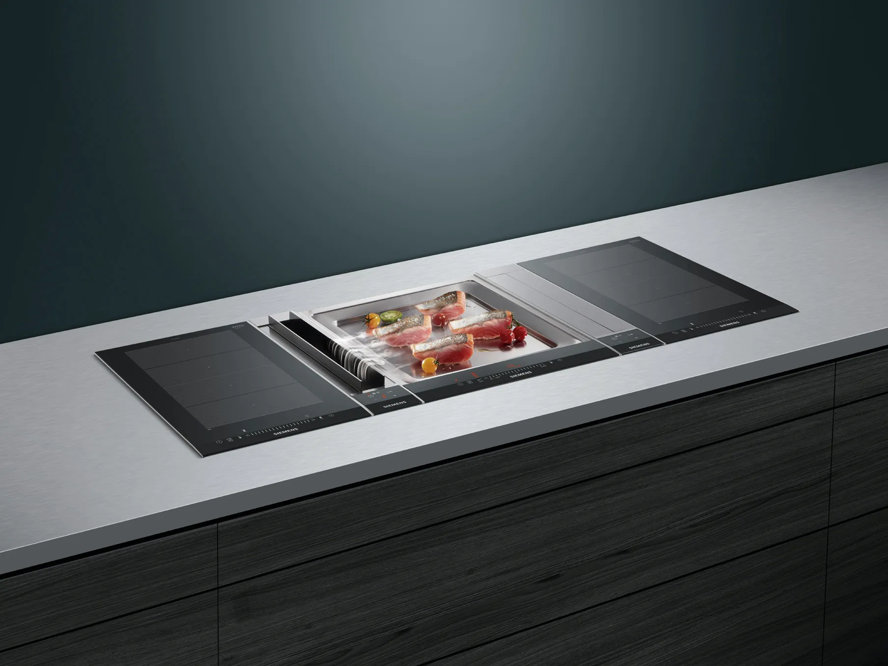 Modern kitchen countertop with built-in induction cooktop and storage drawers.