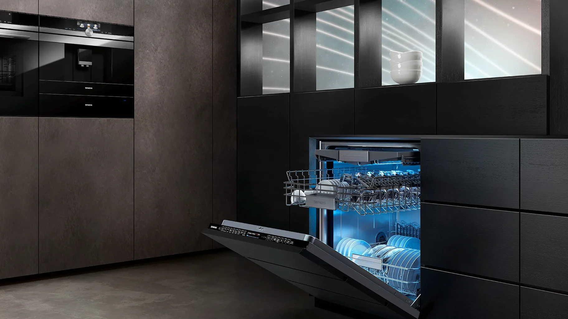 Modern kitchen with sleek black appliances, open dishwasher, and minimalist design.