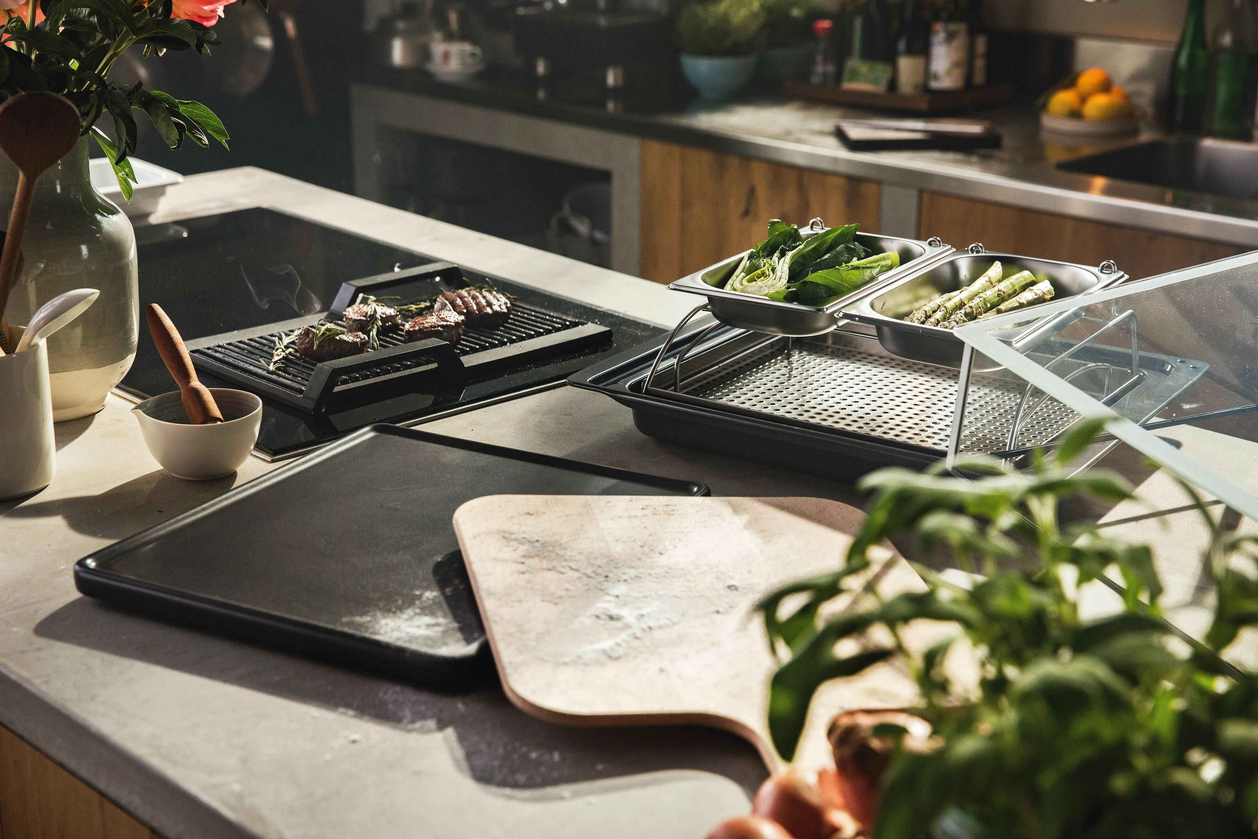 A work surface in the kitchen full of cooking ingredients, pots and pans