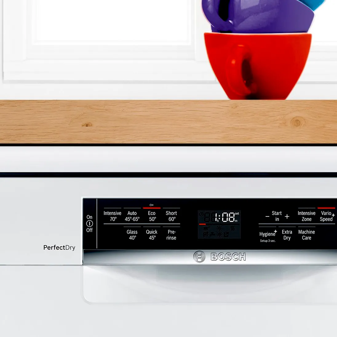 Wooden shelf, red and purple vases, Bosch dishwasher with control panel displaying time.