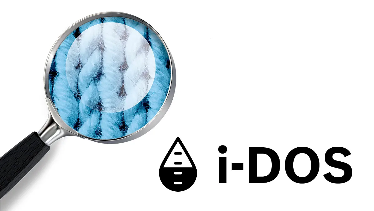 Magnifying glass examining i-DOS logo, revealing abstract blue and white pattern.