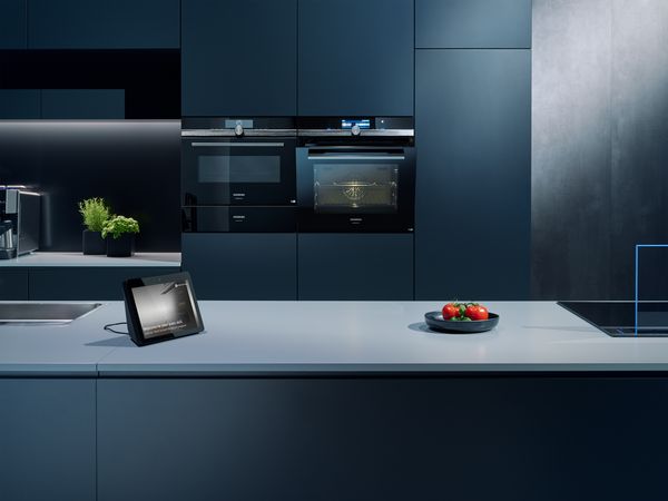 Siemens coffee machine placed in a kitchen next to the Amazon Echo device.