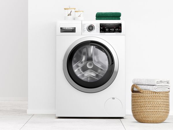 Freistehende Bosch Frontlader-Waschmaschine in einem modernen wei&szlig;en Badezimmer