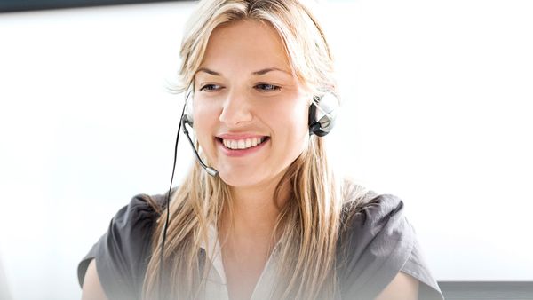 A smiling woman with a headset