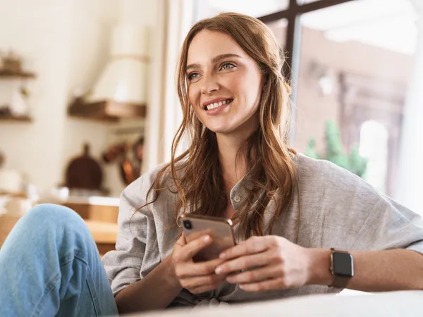 Women on her phone using the HC App