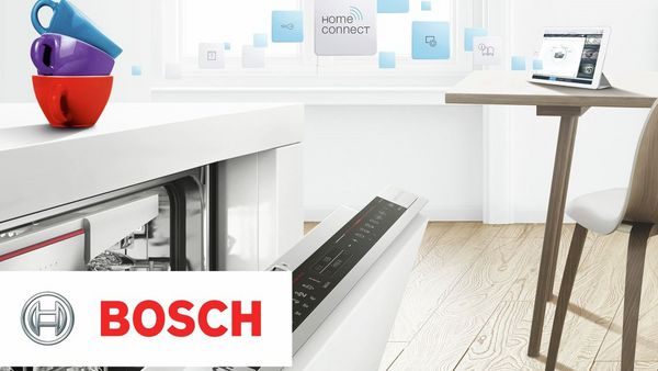 Open dishwasher in a white kitchen with BOSH logo in the corner