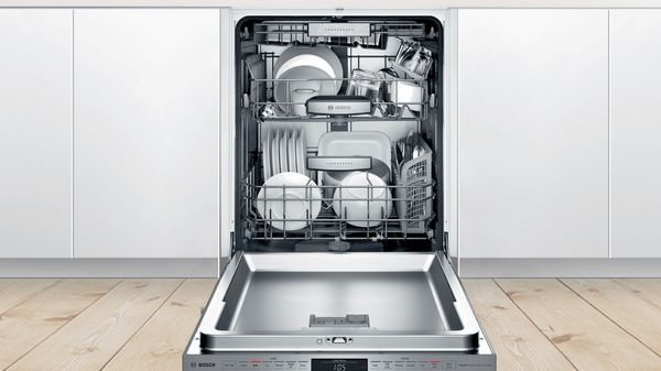 An open and loaded Bosch dishwasher.