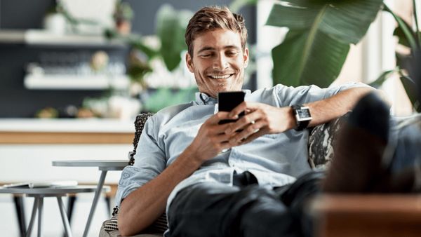 Smiling man looking at phone