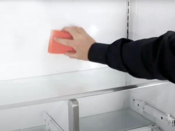 Thermador Refrigeration How to clean a refrigerator talent hand scrubbing back of fridge with sponge