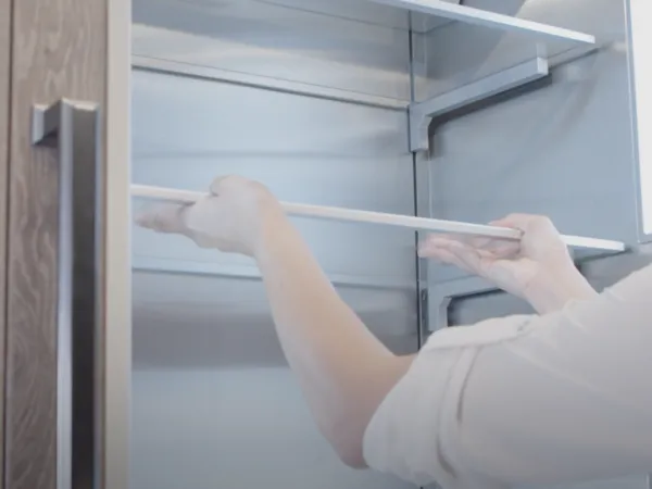 Thermador Refrigeration how to adjust bins and shelves woman adjusting shelf