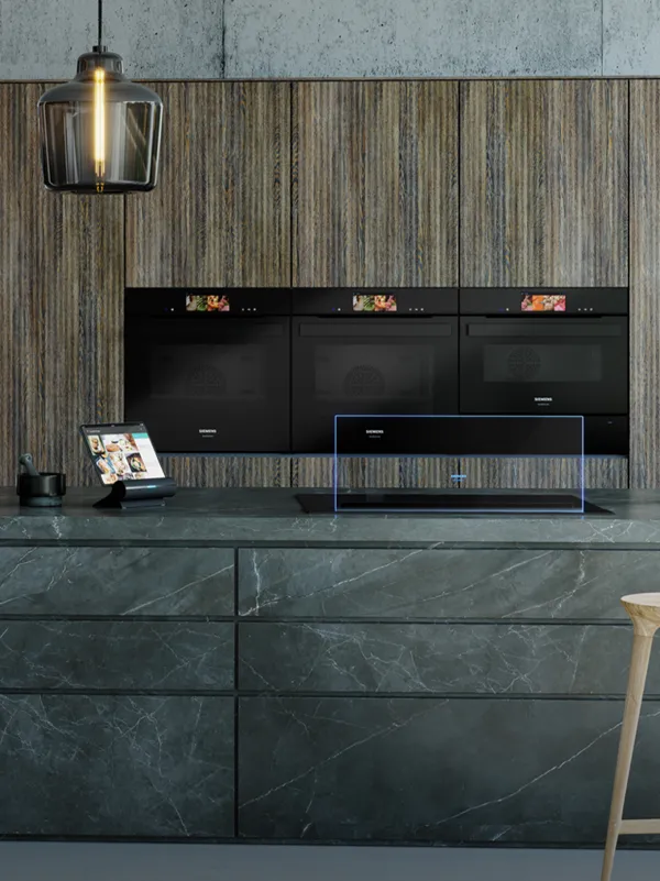A modern kitchen, with three Siemens built-in ovens