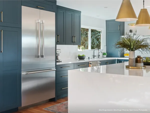 Thermador Bottom Mount Freezers in blue gold kitchen 
