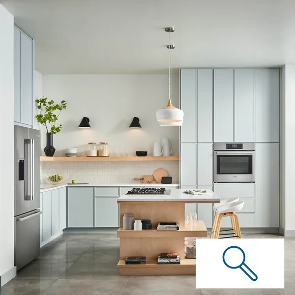 Bosch stainless steel kitchen with blue green cabinets and a magnifying glass