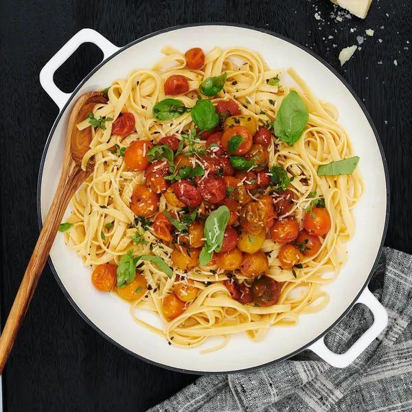 Pot and pasta with wooden spoon