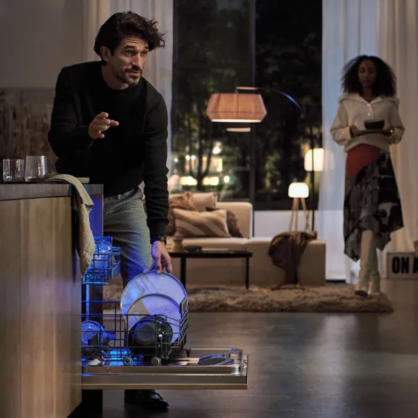 Man unloading a dishwasher