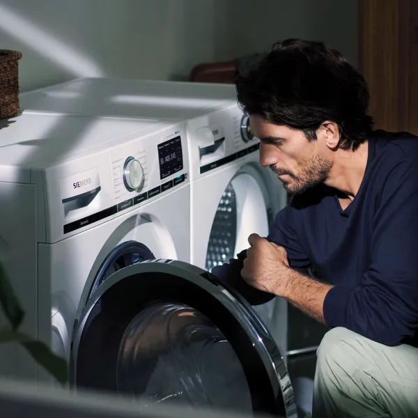 Man loading washing machine