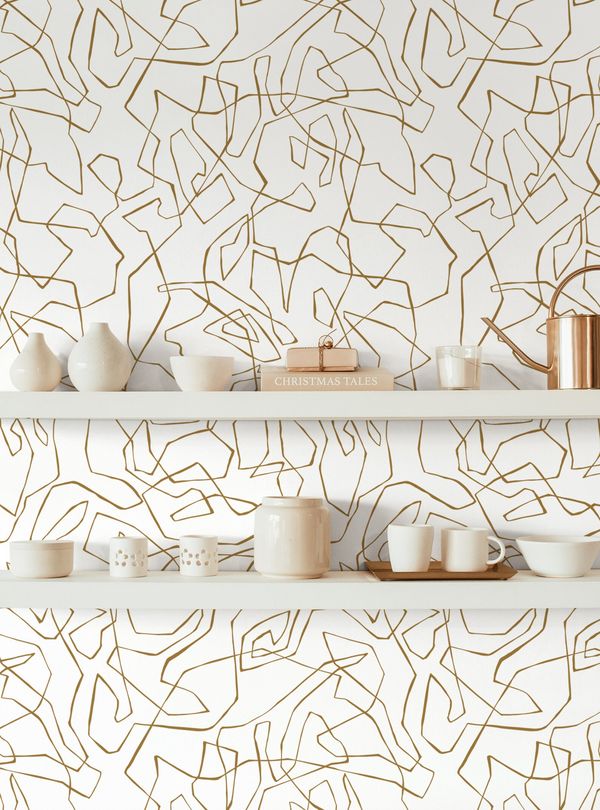 squiggles wallpaper behind white open shelves
