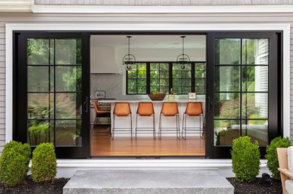 orange stools in a kitchen with blk framed sliding patio doors