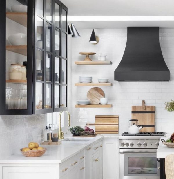 White kitchen with black floating cabinet and oak shelves