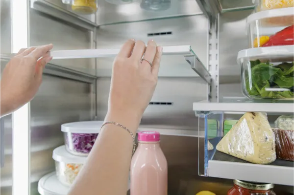 bottom freezer refrigeration hand adjusting split level shelves