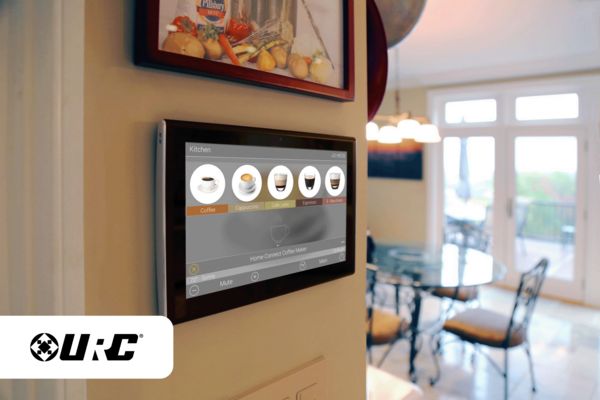 URC Smart Home panel with coffee types on the display fixed to a wall, dining room in the background