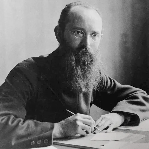 Robert Bosch sitting at a desk with a pen in his hand.