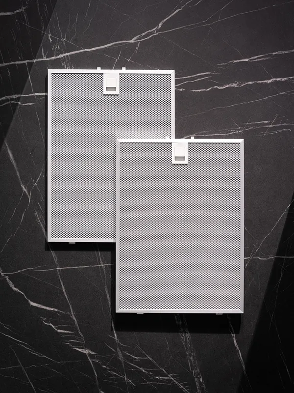 Two rectangular white mesh filters on a dark marble background.