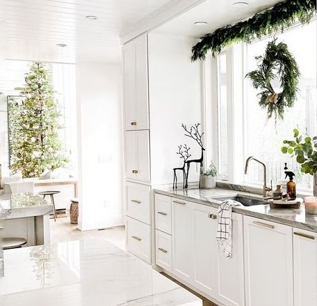 white kitchen with garland and wreath – tree in background