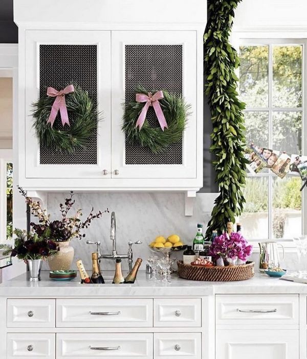 Kitchen with pink bows, champaign in sink and wreaths on cab doors