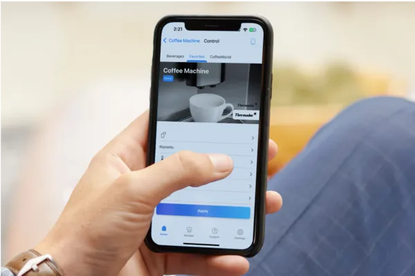 man holding phone looking at mycoffee in app