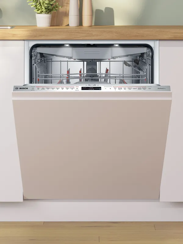 A partially open Bosch dishwasher with a beige panel, revealing its stainless steel interior and control panel, integrated into a modern kitchen with white cabinets and a wooden countertop.