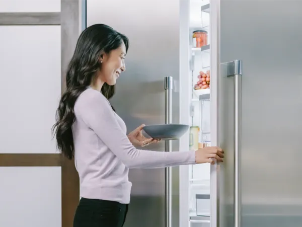 woman opening fridge door