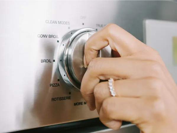 thermador triple ovens closeup hand on professional oven knob