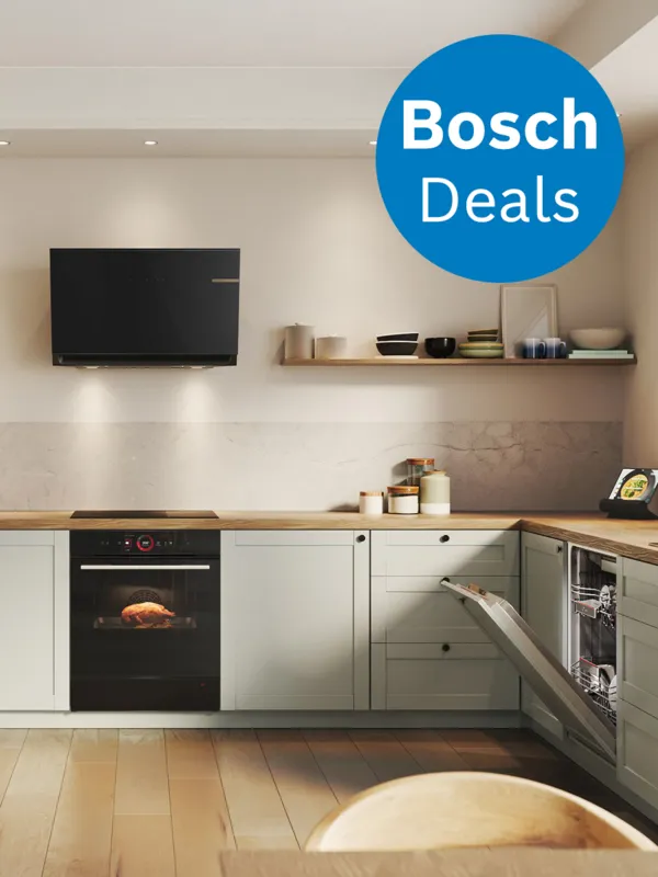 Cuisine moderne avec des armoires vert clair, un four noir et une promotion Bosch mise en avant dans un cercle bleu. Un plat est en train de cuire à l'intérieur du four.